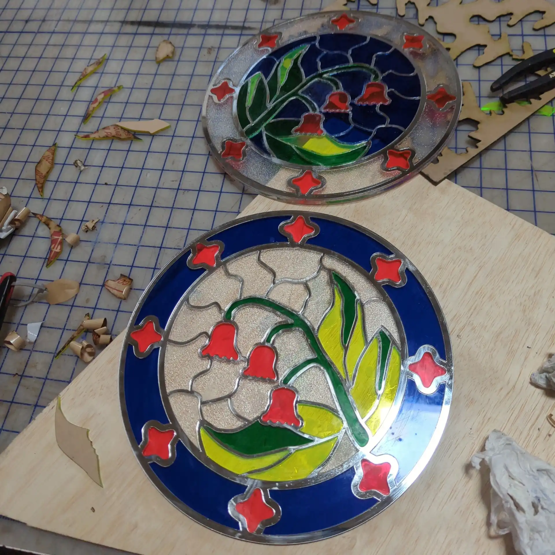 Pieces of acrylic lasercut flower in a stained glass style, mid-assembly